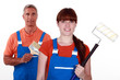 painters in overalls holding brushes