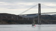 Small fishing Norwegian boat goes on still sea water