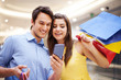 Smiling couple checking something on the mobile phone