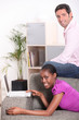 Photo: Couple in their lounge with a laptop computer Couple in their lounge with a laptop computer