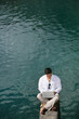 Man with laptop near a lake