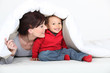 mother and son playing under the blanket