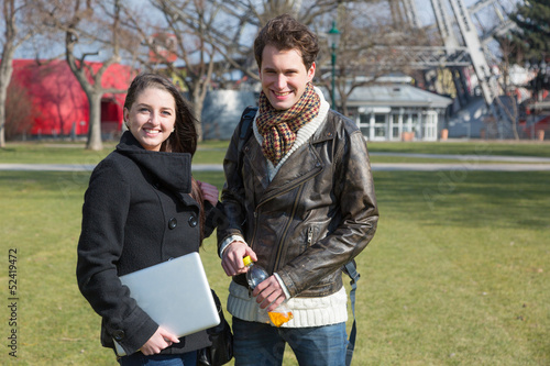 Photo: Young Couple with Computer at Park in Wien Young Couple with Computer at Park in Wien