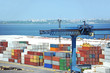 Port cargo crane and container over blue sky background