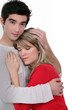 Photo: A man comforting his girlfriend. A man comforting his girlfriend.