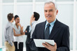 Photo: Businessman Holding Digital Tablet Businessman Holding Digital Tablet