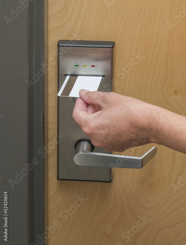 Photo: Keycard being inserted in electronic hotel door lock Keycard being inserted in electronic hotel door lock