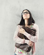 Foto: Thoughtful woman in eyeglasses holding bag. teenager problem Thoughtful woman in eyeglasses holding bag. teenager problem