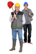 Photo: Construction worker and his apprentice Construction worker and his apprentice