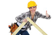Photo: Female carpenter with truss Female carpenter with truss