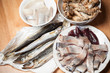 Photo: Seafood theme. Assorted fish on wooden table Seafood theme. Assorted fish on wooden table