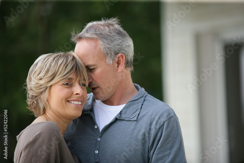 Photo: Married couple stood outside their house Married couple stood outside their house