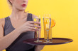 Casual waitress with a tray of drinks