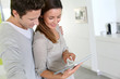Cheerful couple websurfing on internet with tablet