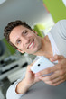 Smiling man in couch using telephone