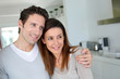 Portrait of cheerful couple standing at home