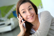 Cheerful brunette girl talking on mobile phone