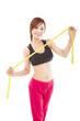Young beautiful asian woman with measure tape
