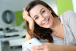 Woman at home relaxing and using smartphone