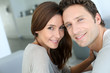 Portrait of sweet couple sitting in sofa