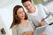 Couple at home looking at internet