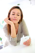 Woman at home relaxing and using smartphone
