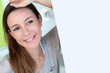Beautiful brunette girl with hand on forehead