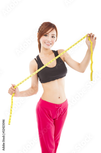 Photo: Young beautiful asian woman with measure tape Young beautiful asian woman with measure tape