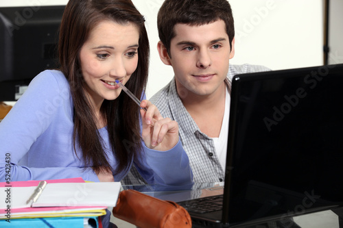 Photo: Two students sat studying together Two students sat studying together