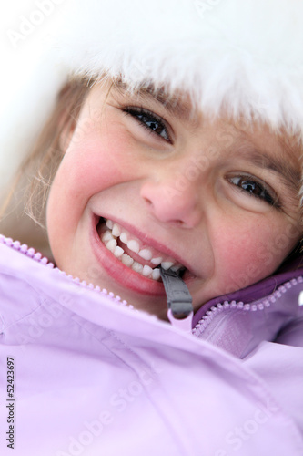 Photo: Little girl stood outdoors in winter clothing Little girl stood outdoors in winter clothing