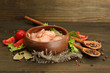 raw chicken meat in bowl, on wooden background