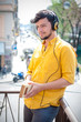 young man reading book and listening music