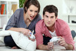 Photo: Couple of teenagers playing video games. Couple of teenagers playing video games.
