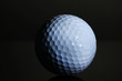 Golf ball on grey background