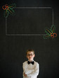 Thinking boy business man with Christmas holly checklist
