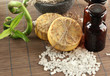 Hand-made soap, bottles and sea salt  on grey bamboo mat