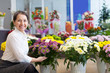 Happy  woman with chrysanthemum at  store