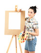 Beautiful young woman painter at work, isolated on white