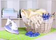 Clothes and iron on table on shelves background
