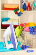 Clothes and iron on table on shelves background