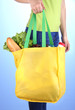 Girl with shopping bag on blue background