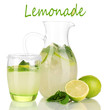 Lemonade in pitcher and glass isolated on white