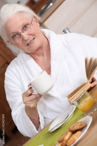 Photo: Elderly woman having breakfast Elderly woman having breakfast