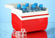 Traveling refrigerator with bottles of water and ice cubes,