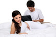 Photo: A young couple in bed. A young couple in bed.