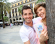 Cheerful couple of tourists at the Plaza Real de Barcelona