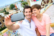 Couple taking picture of themselves in Guell park