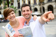 Tourists reading map in the Plaza Real of Barcelona