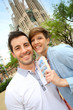 Cheerful couple with travel guide in Barcelona
