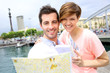 Couple reading touristic map in Barcelona